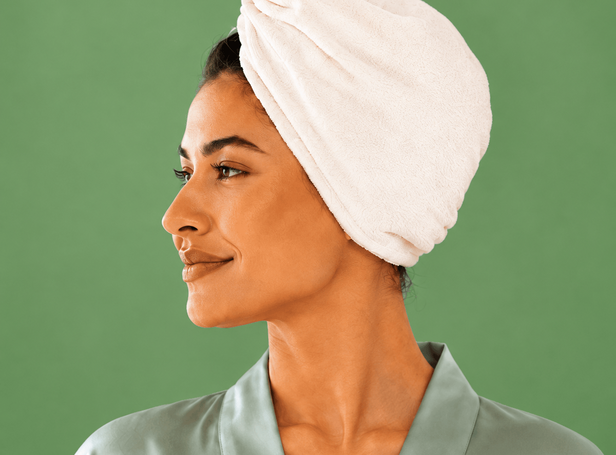 A woman wearing the NIGHT Quick Dry Hair Towel.