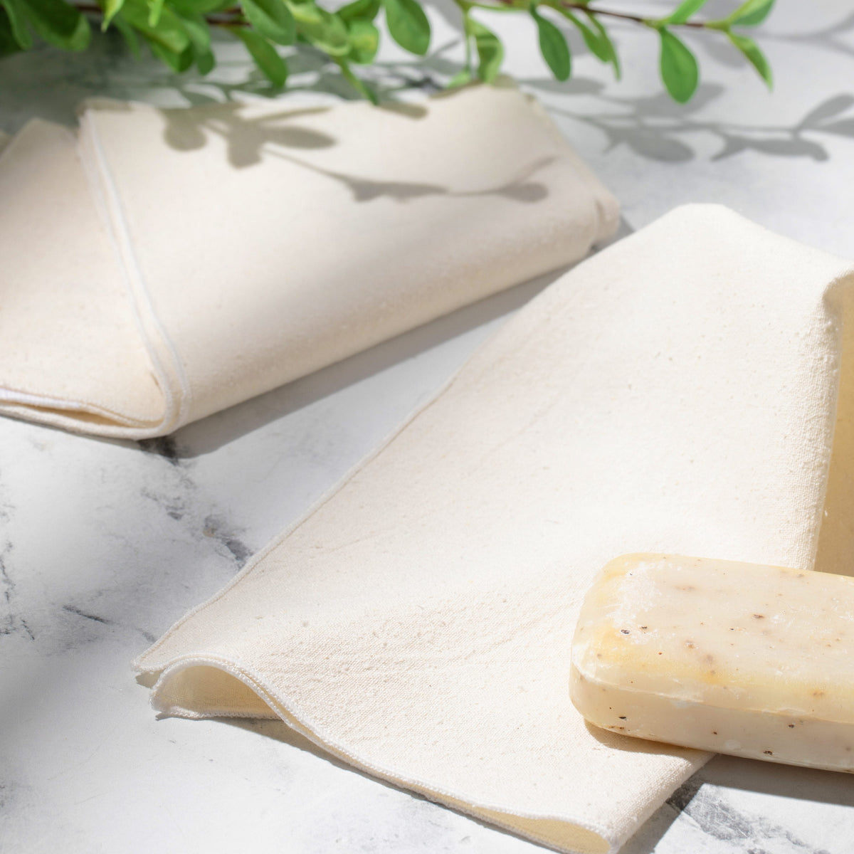 Natural raw silk washcloth texture and stitched edge on marble