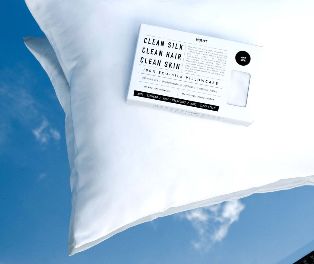 Clean Eco-Silk pillowcase box on top of white eco-silk pillow with reflection of sky in background