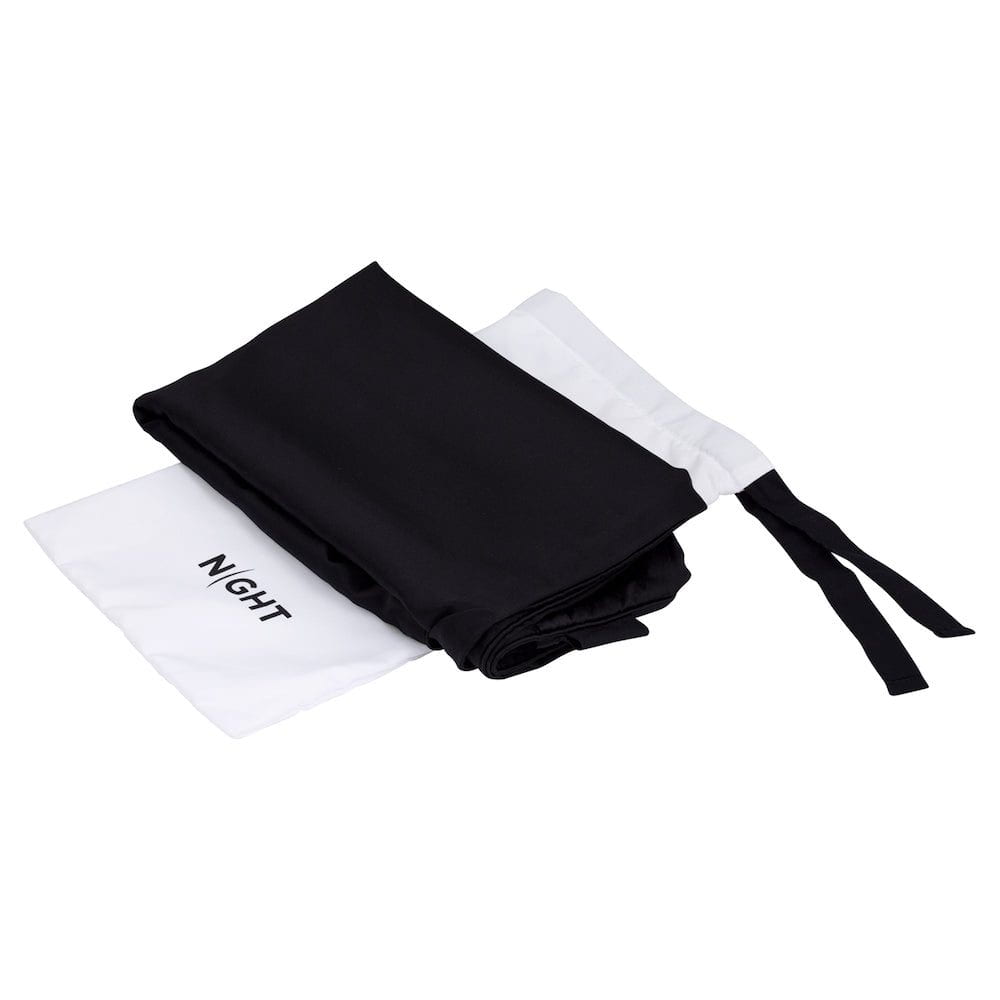 Silk pillowcase in black on top of pouch packaging