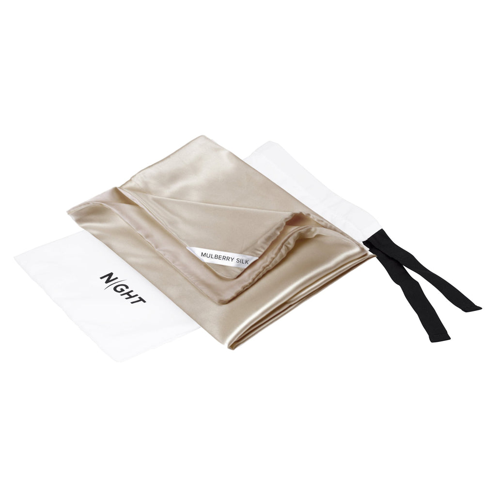 dual sided silk plus pillowcase in champagne sitting on top of packaging