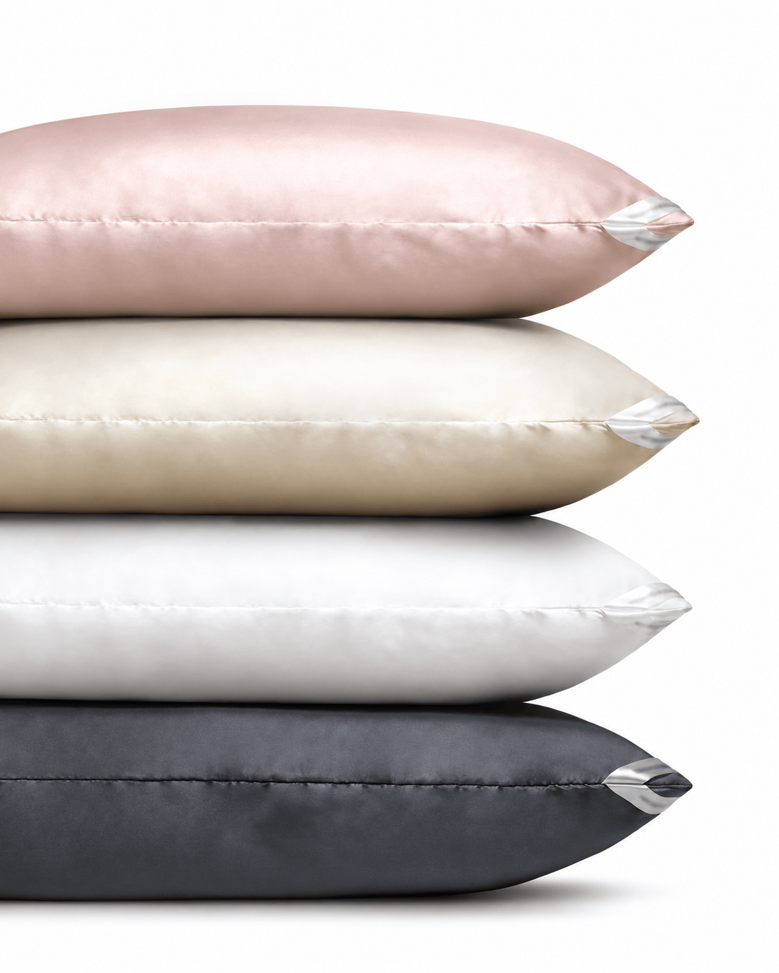Four DualSilk pillowcases stacked in Blush, Champagne, White and Gunmetal. Pillowcases sold individually.