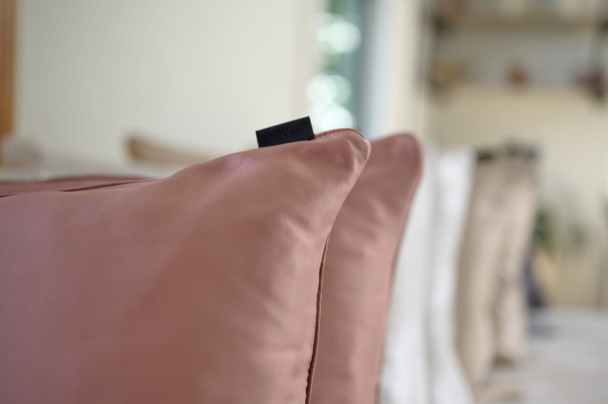 A close view of Blush Mulberry silk, fine piping and the NIGHT woven label.