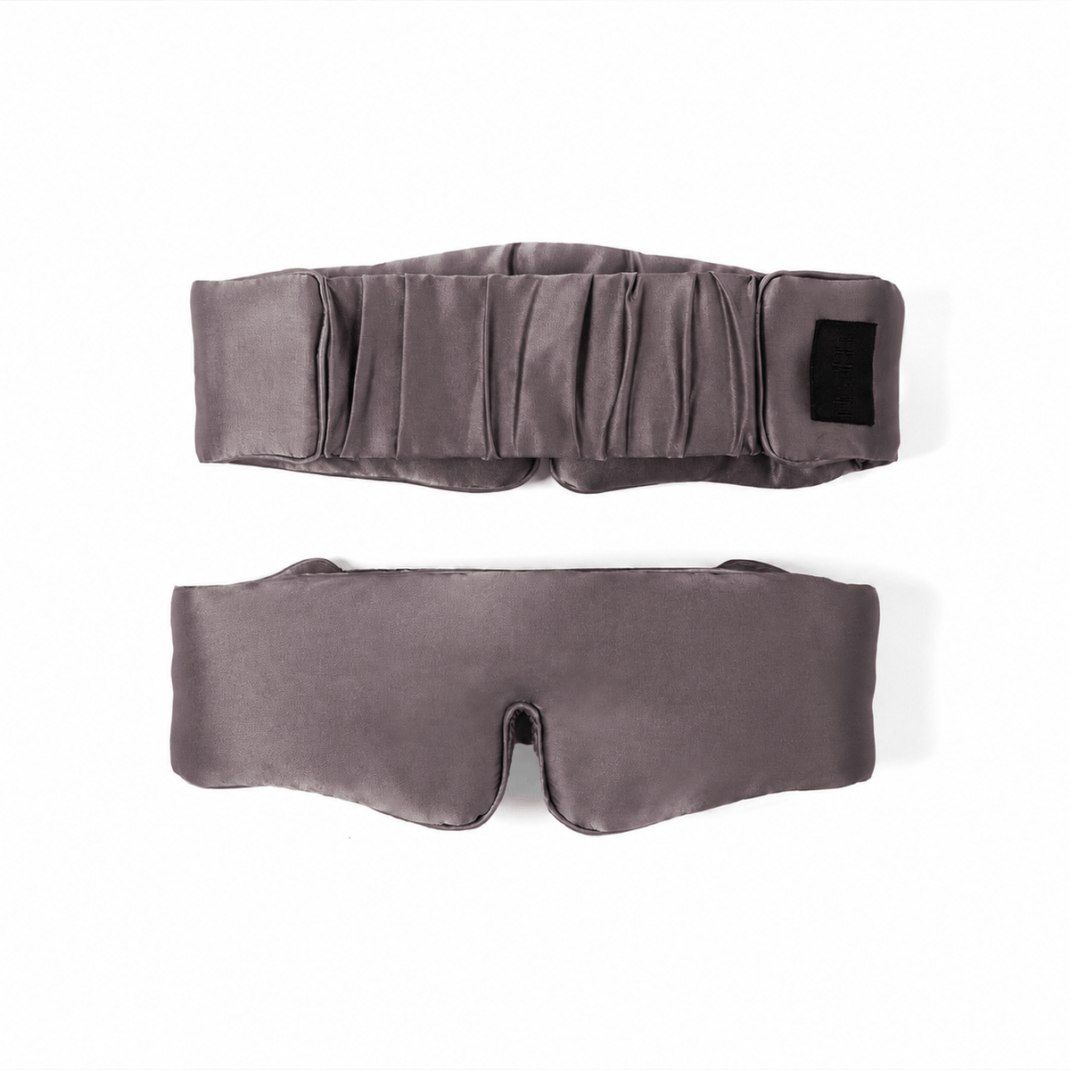 Front and back of the same gunmetal silk sleep mask, showing the adjustable band