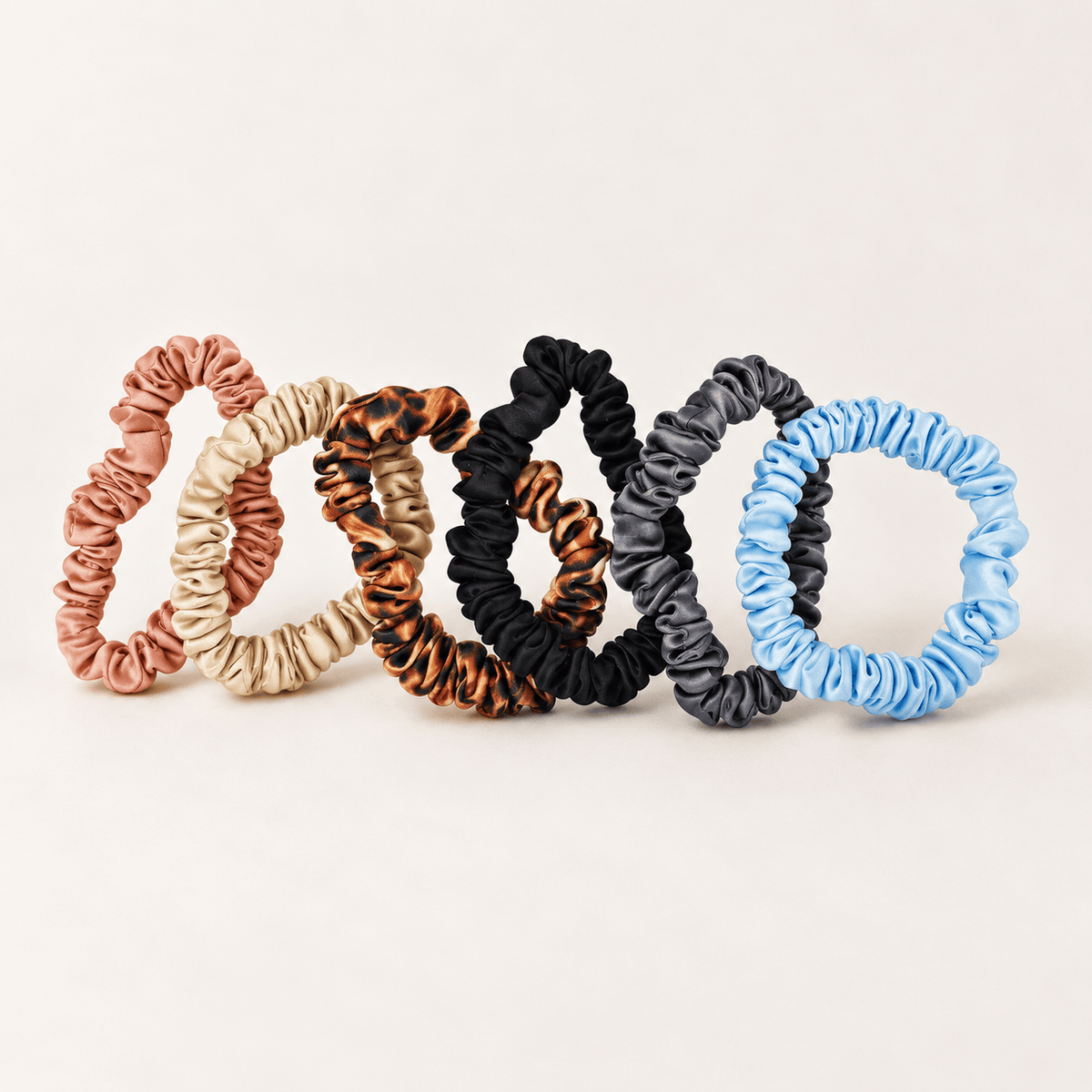 The six-color Skinny silk scrunchie assortment, showing its slim profile
