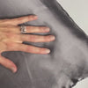 A hand glides across the mulberry silk side of Gunmetal DualSilk in a continuous silent loop