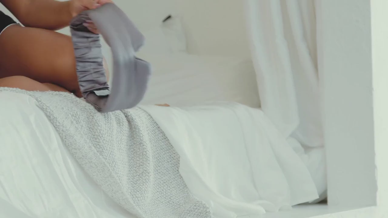 Adjusting and wearing the NIGHT oversized silk eye mask before bed
