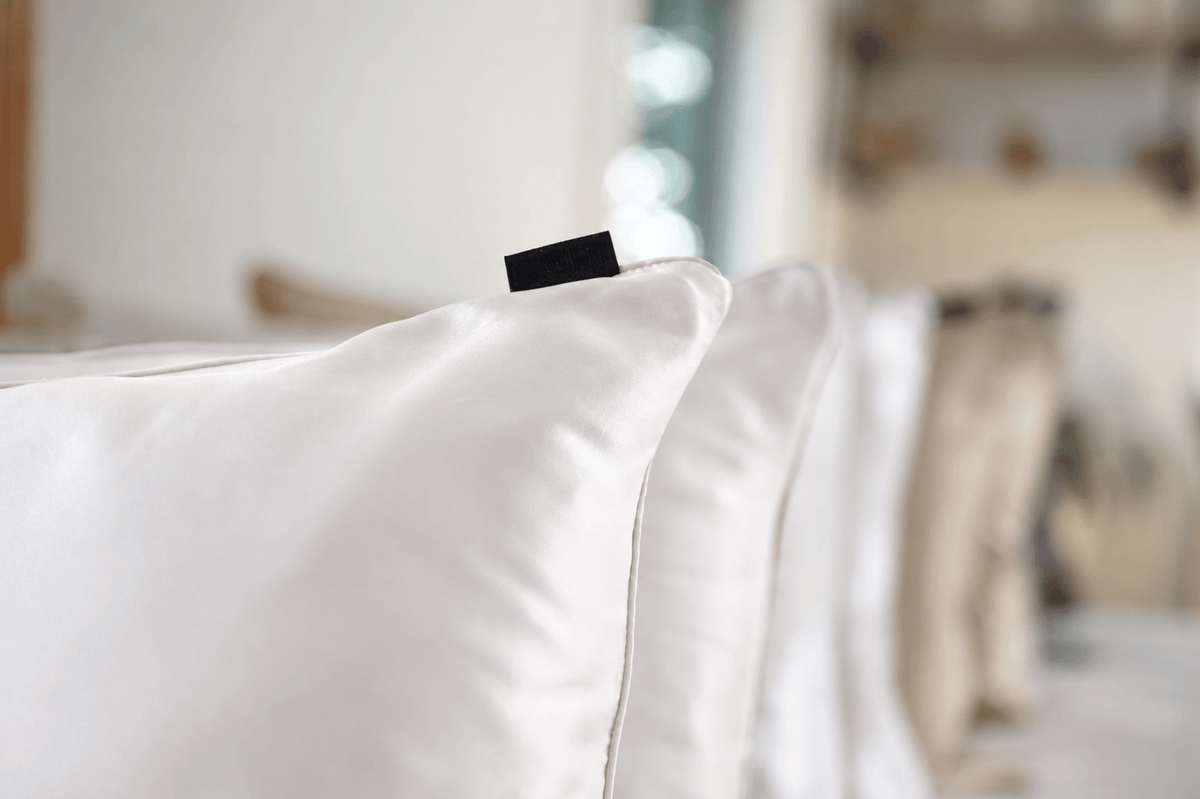 A close view of White Mulberry silk, fine piping and the NIGHT woven label.