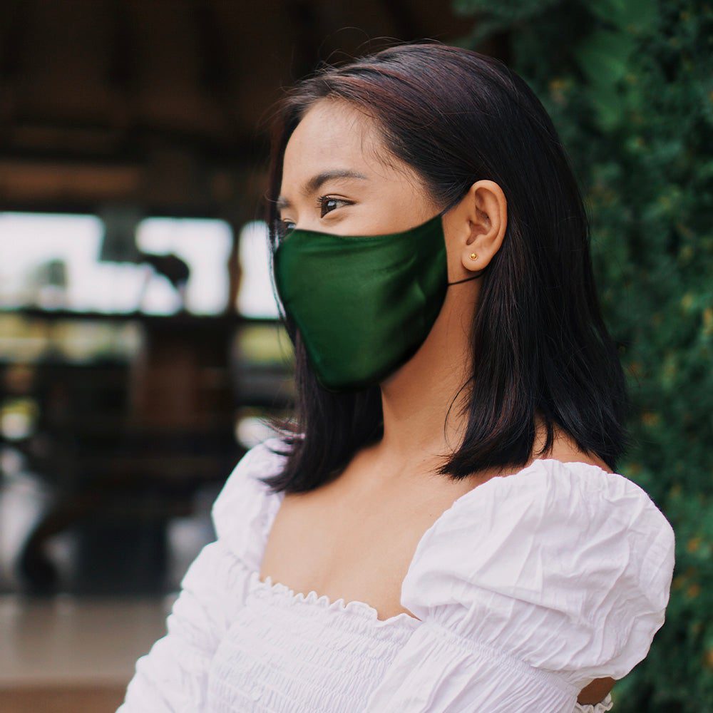 Woman wearing emerald silk face mask
