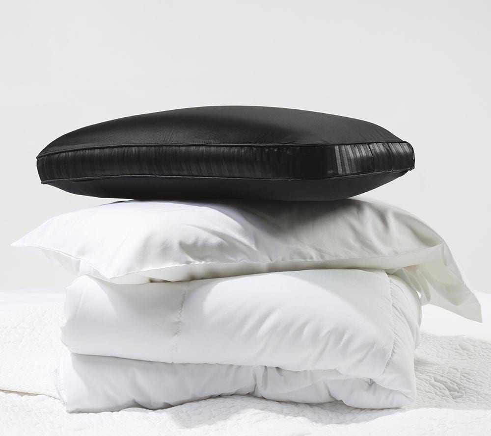 black Night memory foam pillow on top of regular boring white pillows