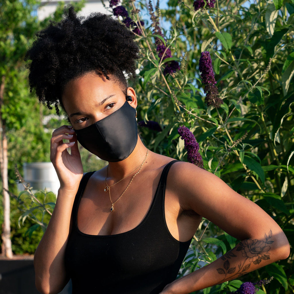 Woman wearing black silk face mask