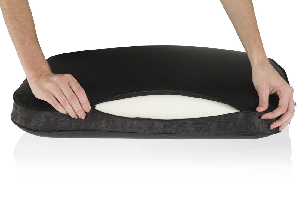 hands opening black pillowcase to reveal Night memory foam pillow