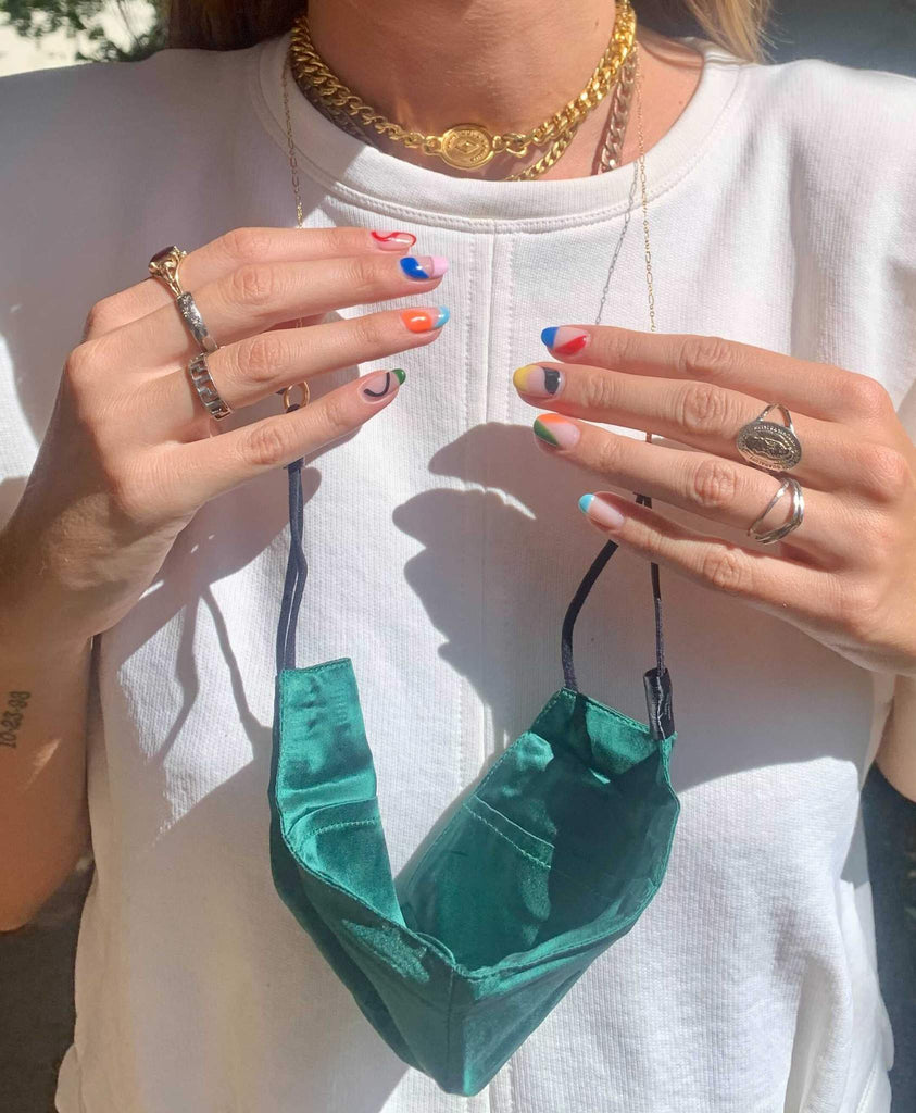 woman with rings wearing Limited Edition Night X Billie Simone jewelry gemini face mask with chain in emerald